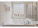 Bright bathroom featuring a soaking tub, glass enclosed shower, and a window with privacy glass at 524 Clarenbridge Dr, Cary, NC 27519