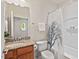 Traditional bathroom featuring a wooden vanity with granite countertop and shower with tree-themed curtain at 524 Clarenbridge Dr, Cary, NC 27519