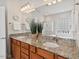 Bathroom featuring a double vanity with granite countertops, decorative lighting and a separate tub and shower at 524 Clarenbridge Dr, Cary, NC 27519