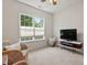Comfortable bedroom with natural light, TV, and two chairs providing ample seating at 524 Clarenbridge Dr, Cary, NC 27519