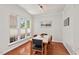Bright dining room featuring hardwood floors, chair rail, and natural light from three windows at 524 Clarenbridge Dr, Cary, NC 27519