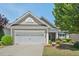 Charming single-story home with a well-manicured lawn and a two-car garage at 524 Clarenbridge Dr, Cary, NC 27519