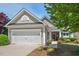 Charming home showcasing a manicured lawn, colorful flowerbeds, and an attached two-car garage at 524 Clarenbridge Dr, Cary, NC 27519