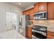 Cozy kitchen with stainless steel appliances, granite countertops, and access to the laundry area at 524 Clarenbridge Dr, Cary, NC 27519