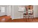 Kitchen area with hardwood floors, breakfast bar seating, and view of a front entry door at 524 Clarenbridge Dr, Cary, NC 27519
