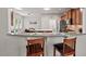 Open concept kitchen and breakfast bar with granite countertops and stainless steel appliances at 524 Clarenbridge Dr, Cary, NC 27519