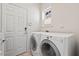 Bright laundry area features modern washer and dryer, window, and convenient access door at 524 Clarenbridge Dr, Cary, NC 27519