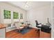 Bright office space with hardwood floors, three large windows, and neutral walls ideal for working at home at 524 Clarenbridge Dr, Cary, NC 27519