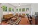 Sun-drenched sun room with hardwood floors, lots of windows and a writing desk at 524 Clarenbridge Dr, Cary, NC 27519