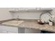 Granite countertop with utility sink, clock, and flower adornment make this the perfect utility area at 524 Clarenbridge Dr, Cary, NC 27519