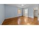 Bedroom with hardwood floors, light blue walls, ceiling fan, and bathroom access at 5529 Shadowbrook Dr, Raleigh, NC 27612