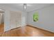 Bedroom with hardwood floors, a double closet, and a bright window at 5529 Shadowbrook Dr, Raleigh, NC 27612