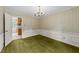 Elegant dining room features decorative wallpaper, classic chandelier, and access to the kitchen at 5529 Shadowbrook Dr, Raleigh, NC 27612