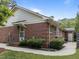 Exterior brick home with lush landscaping, sidewalk, and covered entry at 5529 Shadowbrook Dr, Raleigh, NC 27612