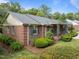 Brick home featuring traditional architecture, green shutters and a covered porch at 5529 Shadowbrook Dr, Raleigh, NC 27612