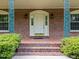 Elegant arched entryway with sidelights and beautiful brickwork on a charming home at 5529 Shadowbrook Dr, Raleigh, NC 27612