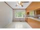 Bright, efficient kitchen featuring a bay window, ample cabinet space, and durable tile flooring at 5529 Shadowbrook Dr, Raleigh, NC 27612