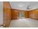 Wood paneled living room with carpet flooring and lots of natural light at 5529 Shadowbrook Dr, Raleigh, NC 27612
