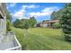 Condo backyard with lush green lawn, mature trees, and easy access to all units, perfect for recreation and relaxation at 5602 Falls Of Neuse Rd # E, Raleigh, NC 27609