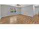 Bright, spacious bedroom with sleek ceiling fan and lovely wood-look floors at 5602 Falls Of Neuse Rd # E, Raleigh, NC 27609