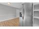Hallway with stainless steel refrigerator on the way to the doorway at 5602 Falls Of Neuse Rd # E, Raleigh, NC 27609