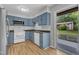 Well-lit kitchen with white appliances and shaker style cabinetry, leading to deck at 5602 Falls Of Neuse Rd # E, Raleigh, NC 27609