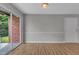 Spacious living room with hardwood floors, natural light, and a sliding glass door to the patio at 5602 Falls Of Neuse Rd # E, Raleigh, NC 27609