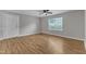 Bright living room with laminate flooring, a ceiling fan, and a window at 5602 Falls Of Neuse Rd # E, Raleigh, NC 27609