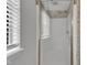 The shower has a glass door and is tiled in tans and whites at 5602 Falls Of Neuse Rd # E, Raleigh, NC 27609