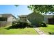 View of the backyard with a wooden deck and a stone pathway leading to the house at 65 Wood Green Dr, Wendell, NC 27591