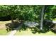 View of the backyard fire pit area surrounded by trees and a stone path at 65 Wood Green Dr, Wendell, NC 27591