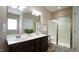 Spacious bathroom featuring double sinks, tiled floor, and walk-in shower at 65 Wood Green Dr, Wendell, NC 27591