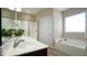 Bright bathroom with bathtub, glass enclosed shower, and double sinks at 65 Wood Green Dr, Wendell, NC 27591