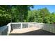 Private wooden deck surrounded by lush greenery and offering views of the backyard at 65 Wood Green Dr, Wendell, NC 27591