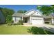 Single-Gathering home boasts beautiful landscaping, a two-car garage, and a well-manicured lawn at 65 Wood Green Dr, Wendell, NC 27591