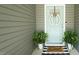 Charming front door with a decorative wreath, plants, and a 'Sweet Home' welcome mat at 65 Wood Green Dr, Wendell, NC 27591
