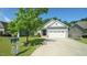 This home features a well-kept front yard, two-car garage, and inviting curb appeal at 65 Wood Green Dr, Wendell, NC 27591