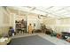 A clean and organized garage interior with storage shelves, gray carpet, and blue door at 65 Wood Green Dr, Wendell, NC 27591