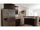 Modern kitchen featuring stainless steel appliances, dark cabinets and breakfast bar at 65 Wood Green Dr, Wendell, NC 27591