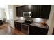 Cozy kitchen featuring modern stainless steel appliances and dark cabinets at 65 Wood Green Dr, Wendell, NC 27591