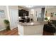 Well-lit kitchen featuring dark cabinets, stainless steel appliances, and a breakfast bar at 65 Wood Green Dr, Wendell, NC 27591