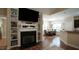 Open-concept living room featuring a fireplace, built-ins, and wood-look flooring at 65 Wood Green Dr, Wendell, NC 27591