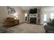 Cozy living room featuring a fireplace, built-ins, and wood-look flooring at 65 Wood Green Dr, Wendell, NC 27591