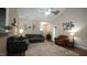 Welcoming living room featuring vaulted ceiling, ceiling fan, sofas, and wood-look flooring at 65 Wood Green Dr, Wendell, NC 27591