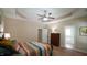 Comfortable main bedroom featuring a tray ceiling, ceiling fan, and furnishings at 65 Wood Green Dr, Wendell, NC 27591