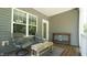 Relaxing covered patio with outdoor seating and natural light from a large window at 65 Wood Green Dr, Wendell, NC 27591