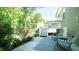 Covered patio with outdoor seating and landscaped backyard is easily accessible via stairs and a pathway at 65 Wood Green Dr, Wendell, NC 27591