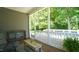 Inviting open porch with wood flooring and white railing, overlooking a lush green space at 65 Wood Green Dr, Wendell, NC 27591
