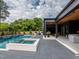 An expansive backyard with a pool, patio, and the home's modern exterior at 661 Manchester Dr, Raleigh, NC 27609