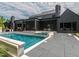 Beautiful backyard with a pool, hot tub, and a dark, modern house at 661 Manchester Dr, Raleigh, NC 27609